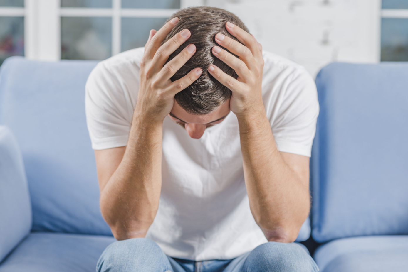Man Holding Head Couch